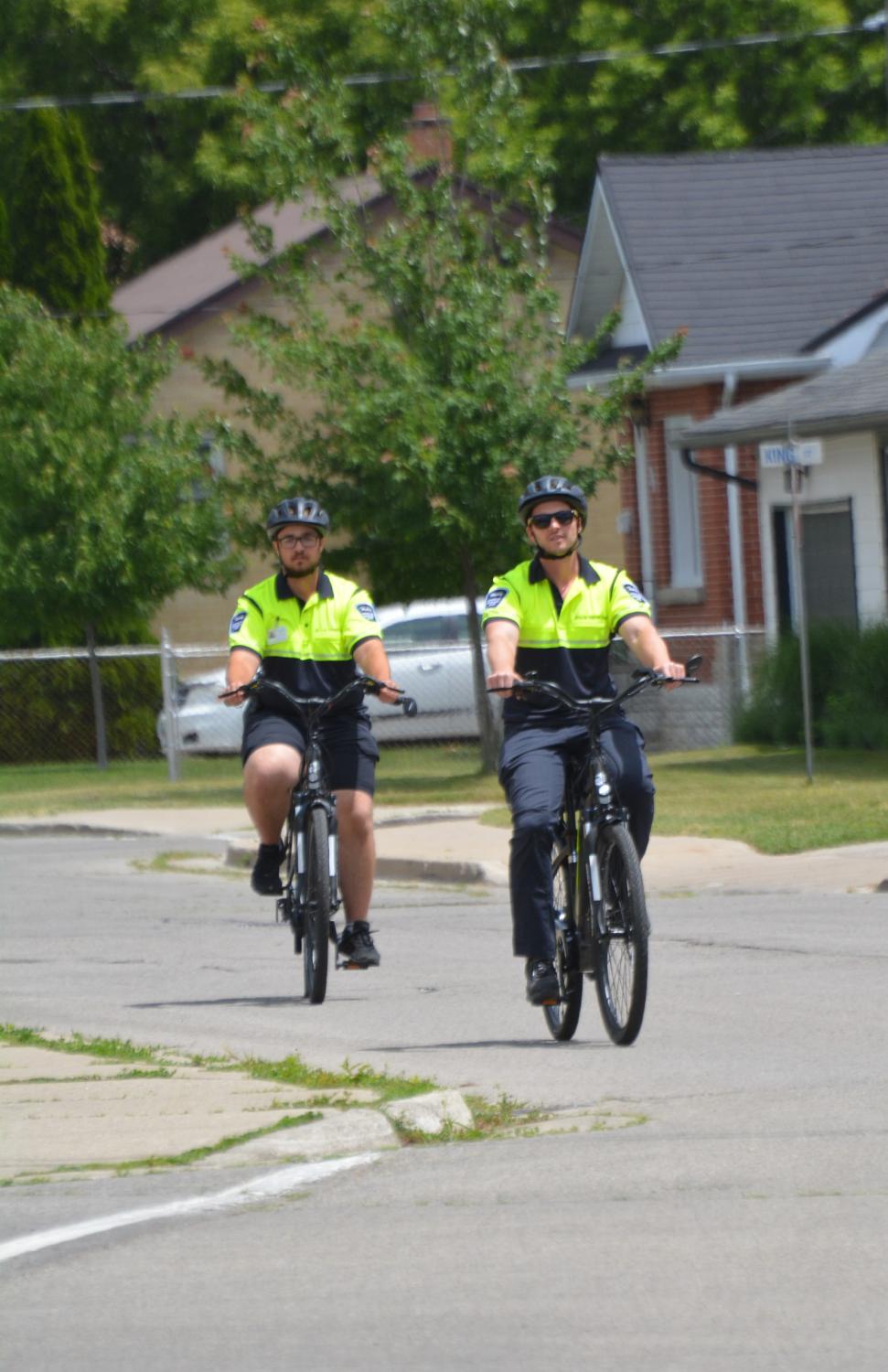 Two bylaw officers on bikes