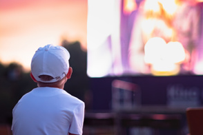 Child watching a movie outside